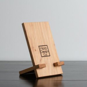 Wooden mobile phone stand on modern work desk – stylish accessory